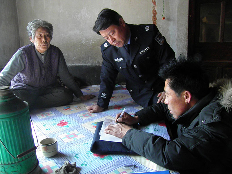 阜蒙縣司法局副局長(zhǎng)張彪(中）在受助村民家中走訪